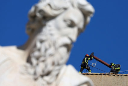 Vatican firefighters install chimney on Sistine Chapel roof for papal election