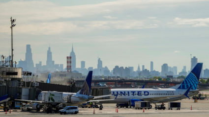 United Airlines planes are seen at the tarmac at Newark International Airport as the skyline of New York is seen in the ba...
