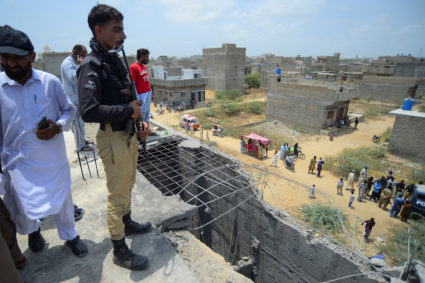 Police officer stands at the site where according to the Crime Scene Unit (CSU), a drone was brought down, on the outskirt...