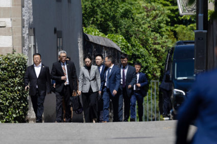 Members of the Chinese delegation leave a residence where trade talks between Chinese and U.S. delegations take place in G...