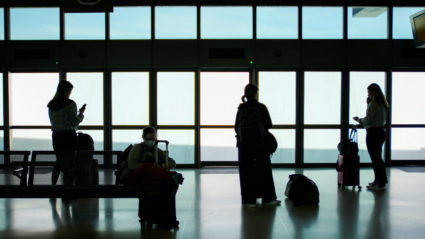 People wait for the air train to connect with their flights at Newark International Airport in Newark, New Jersey