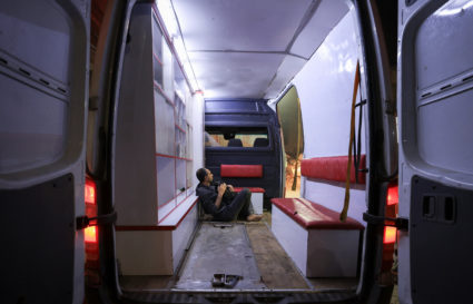 A Palestinian sits in an ambulance following an Israeli strike at a school sheltering displaced people, in Gaza City