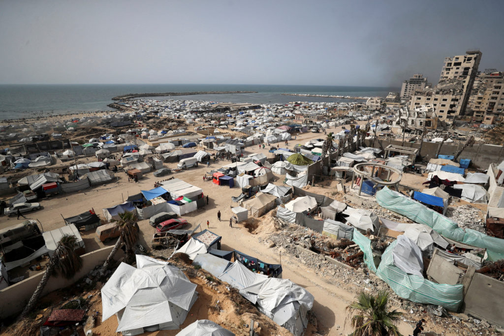 Palestinians displaced by the Israeli military offensive take shelter in tents near Gaza's seaport, in Gaza