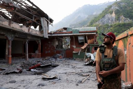 Pakistan Army soldier stands at the premises of the Bilal Mosque, after it was hit by an Indian strike in Muzaffarabad