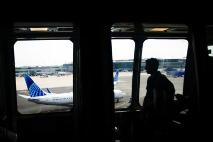 A man rides the air train to connect with his flight at Newark International Airport in Newark, New Jersey