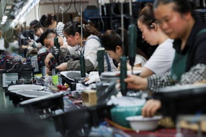 Employees of Gstar Electronic Appliance Co., Ltd work to assemble air fryers in the factory