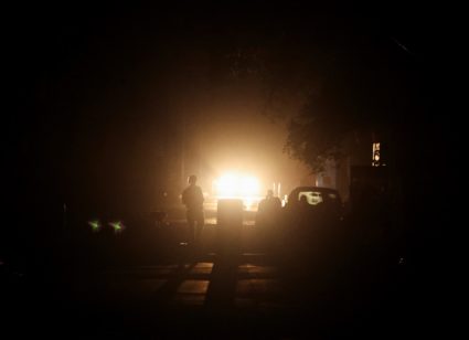 A man walks on a street during a blackout in the city of Amritsar