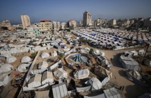 Palestinians displaced by the Israeli military offensive, shelter in tents, in Gaza City