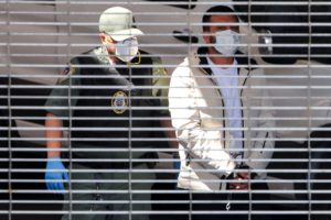 Man in handcuffs is loaded into a van at a garage of the Edward R. Roybal Federal Building and United States Courthouse in...