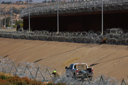 Members of the U.S. military replace concertina wire at on the U.S.-Mexico border, as seen from Ciudad Juarez