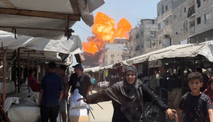 Smoke and flames rise from a house hit by an Israeli strike in Gaza City