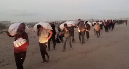 Palestinians carry aid supplies received from the U.S.-backed Gaza Humanitarian Foundation, in Rafah