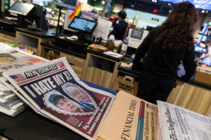 A newspaper front page featuring U.S. President Donald Trump and Elon Musk is displayed in Arlington