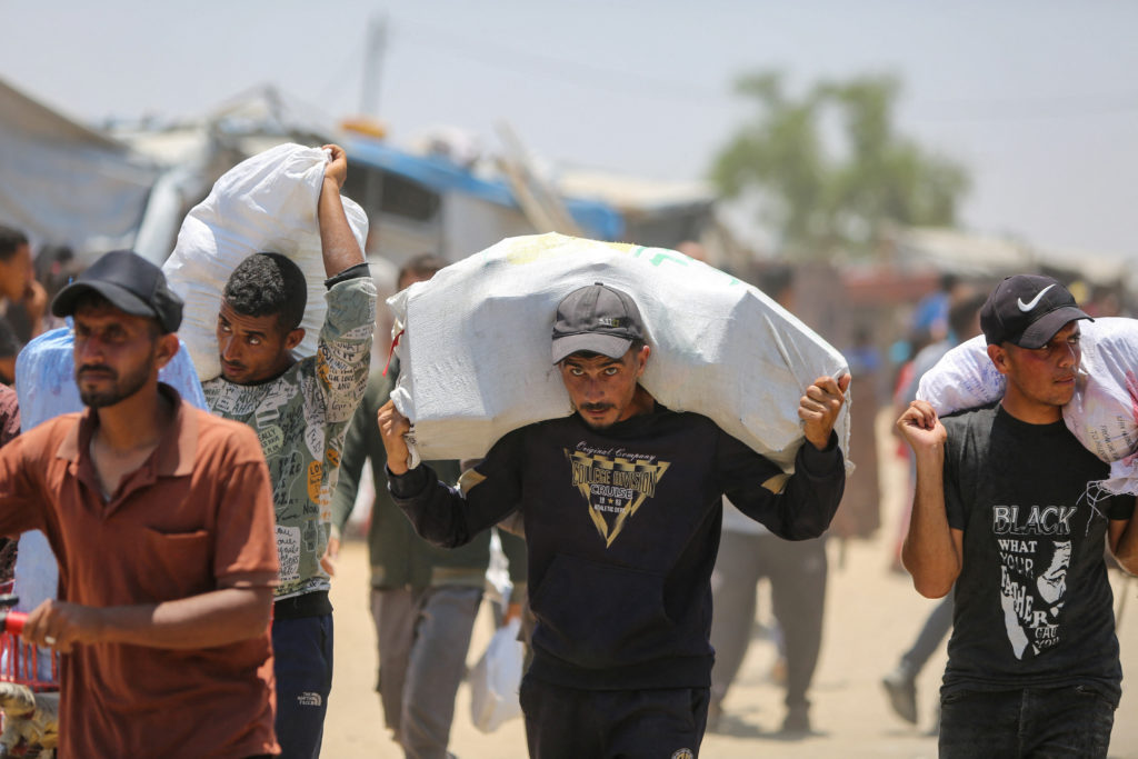 Palestinians gather to collect aid supplies from the U.S.-backed Gaza Humanitarian Foundation, in Rafah