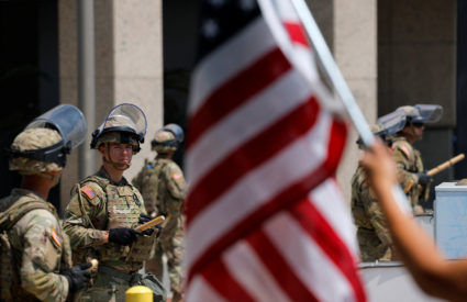 Members of the California National Guard stand guard outside the Edward R. Roybal Federal building as protests against fed...