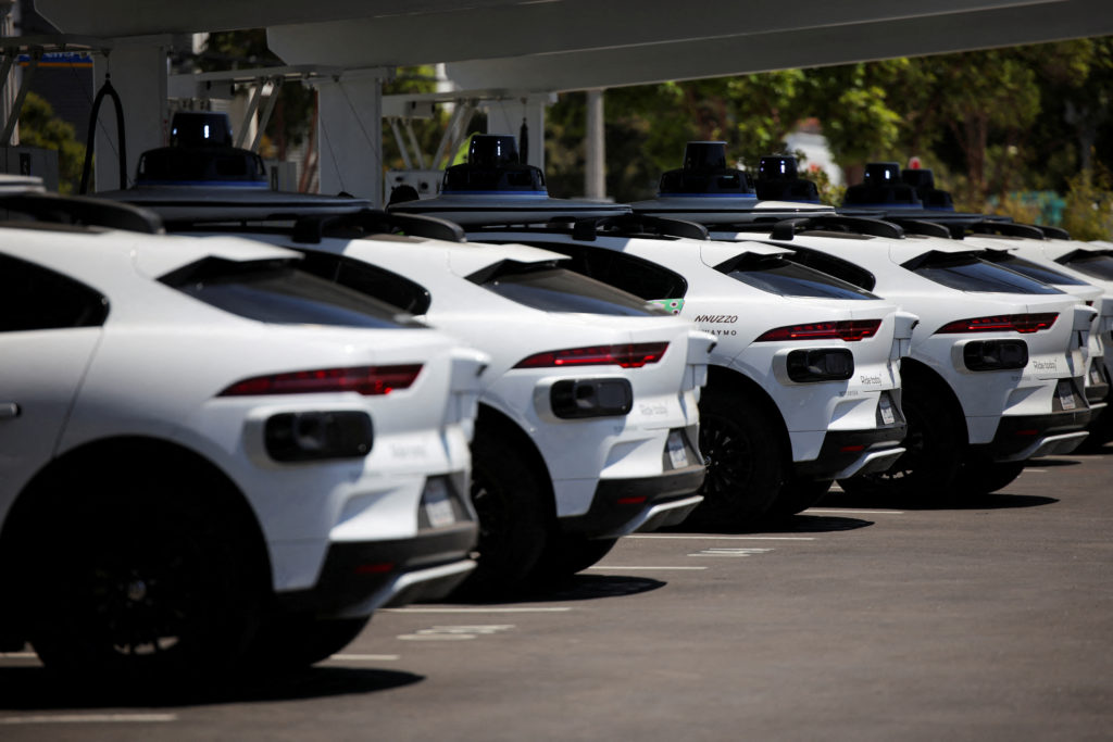 FILE PHOTO: Waymo driverless vehicles charge at a Waymo charging station in Santa Monica