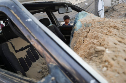 Palestinians gather at the site of a tent camp that was struck by an Israeli airstrike on Friday, in Gaza City