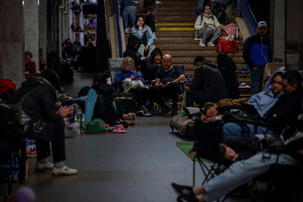 People take shelter inside a metro station during a Russian military strike in Kyiv