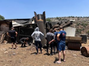 People look at an apparent remains of a ballistic missile following missile attack by Iran on Israel earlier today, in nor...