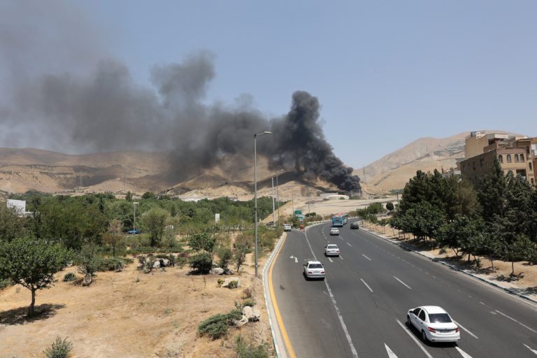 Smoke rises following what Iran says was an Israeli attack on Sharan Oil depot in Tehran