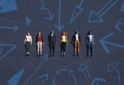 Businesspeople lying down on painted asphalt with arrows pointing