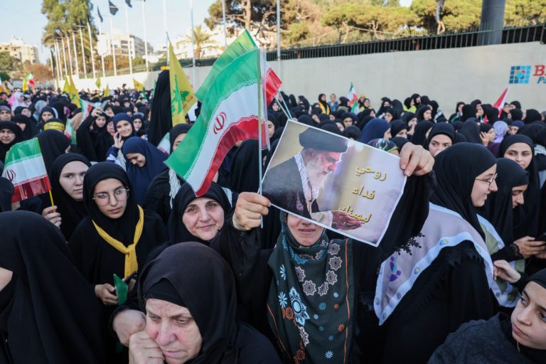 People celebrate what they say is Iran's victory, at the Iranian embassy in Beirut