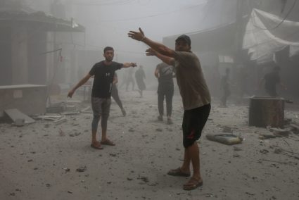 Palestinians inspect the damage at the site of an Israeli strike on a house, in Gaza City