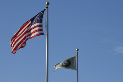 Flags wave in the breeze at the U.S. Border Patrol Central Processing Center known as "Ursula" in McAllen