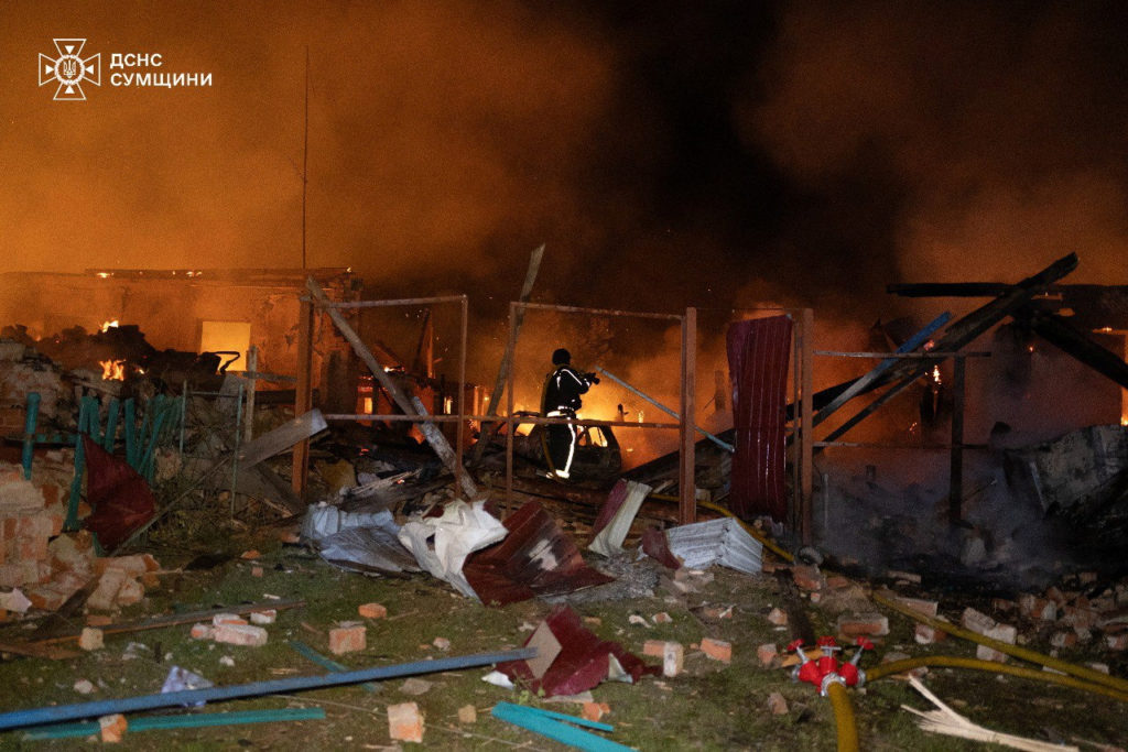 Emergency personnel work following a Russian drone attack at a location given as Sumy region