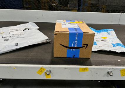 FILE PHOTO: Amazon packages move down a conveyor belt on Prime Day
