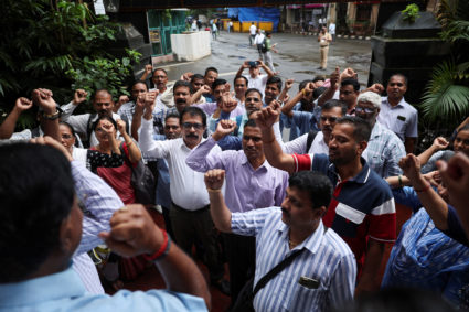 Bank employees shout slogans outside a bank during a nationwide strike in Mumbai