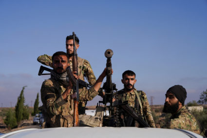 Members of Syrian security forces ride on a back of a truck after Syrian troops entered the predominantly Druze city of Sw...