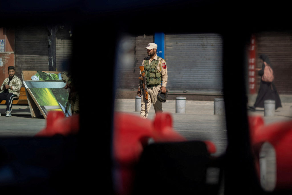 FILE PHOTO: An Indian security force personnel stands guard on a street in Srinagar