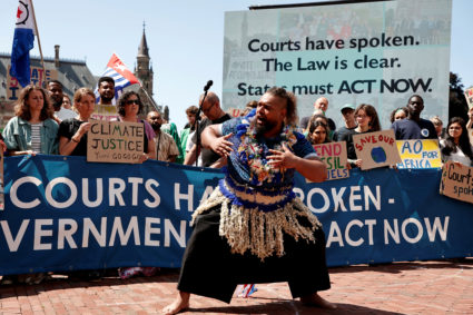 Climate activists and campaigners demonstrate outside the International Court of Justice (ICJ) in The Hague