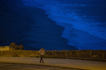 A person walks along Ocean Beach, after authorities warned residents of the possibility of tsunami waves, following an ear...