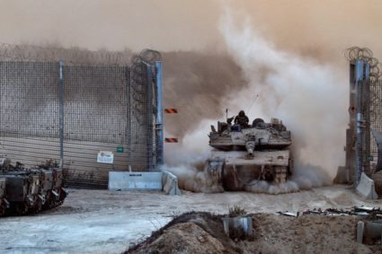 An Israeli tank enters Israel from Gaza
