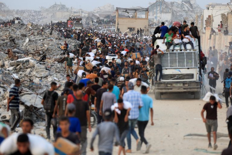 Palestinians receive aid supplies in Beit Lahia