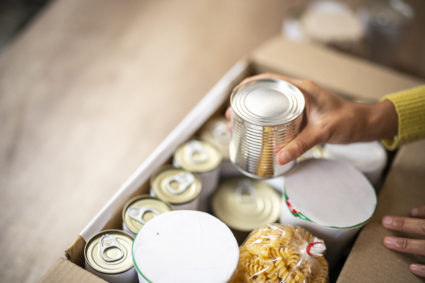 working at charitable foundation, packing donation box