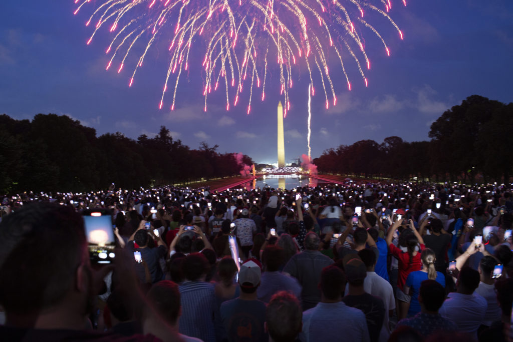 Attendees watch the Independence Day fireworks display along