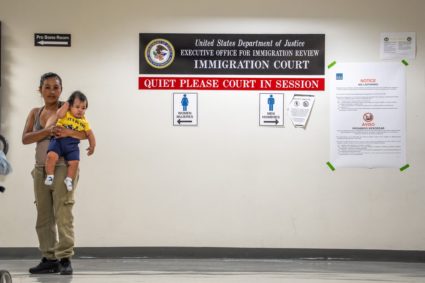 A woman stands in the hallway as her husband attends a hearing at U.S. immigration court in New York City