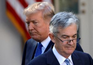 FILE PHOTO: U.S. President Donald Trump looks on as Jerome Powell, his nominee at the time to lead the Fed, moves to the p...