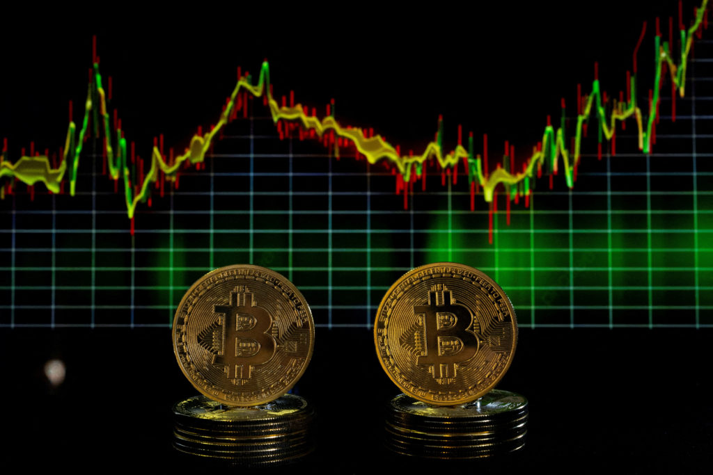 FILE PHOTO: Bitcoin tokens and a price chart are seen in this illustration picture