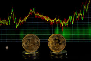 FILE PHOTO: Bitcoin tokens and a price chart are seen in this illustration picture