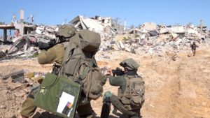 Israeli soldiers operate amid ruins of buildings in Gaza Strip