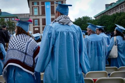 Graduating students wearing keffiyehs attend Columbia University's commencement ceremony on its main campus, in Manhattan,...