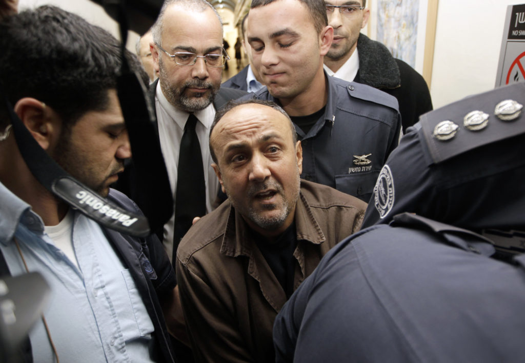 Jailed Fatah leader Barghouti is accompanied by Israeli prison guards in Jerusalem