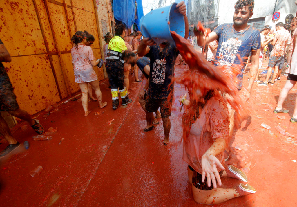 Revellers play with tomato pulp during the annual "Tomatina" festival in Bunol