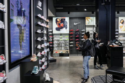 A customer looks at shoes at a Footlocker store in New York City