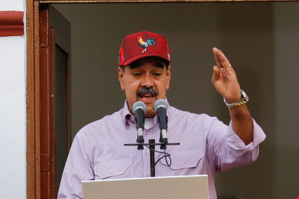 Venezuelan President Nicolas Maduro addresses supporters during a march marking the first anniversary of his victory in th...