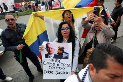People protest against former Colombia's President Alvaro Uribe following his criminal conviction, outside the Paloquemao ...